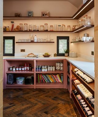 walk in pantry with small windows at end, open shelving on wall with LED lighting strips and open cabinet shelving below