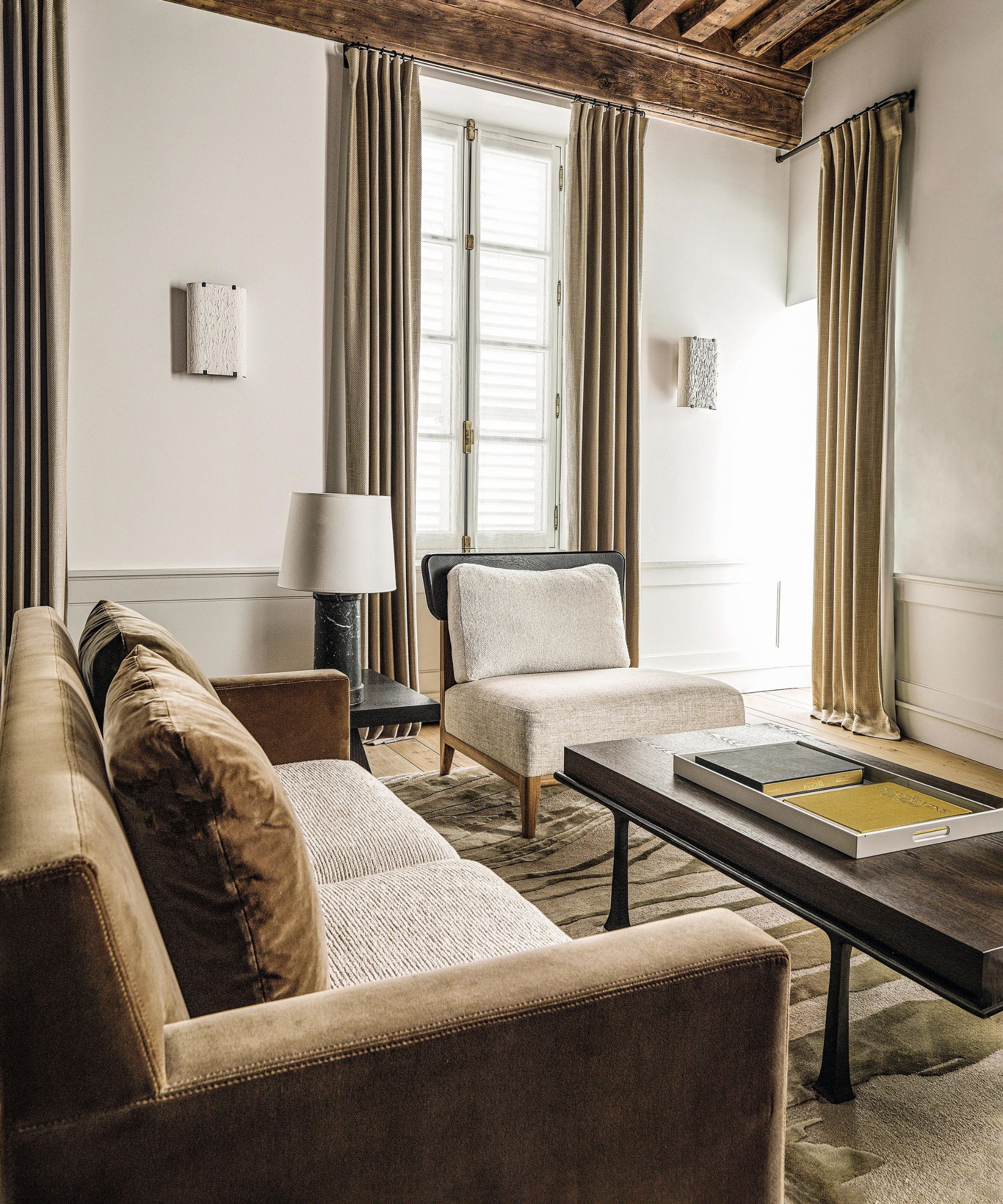 a rustic living room in france decorated with modern furniture