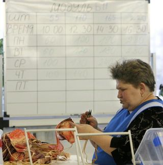 Russian woman stitching bra