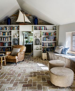 Bookshelf ideas for living rooms with white shelves and stone floor