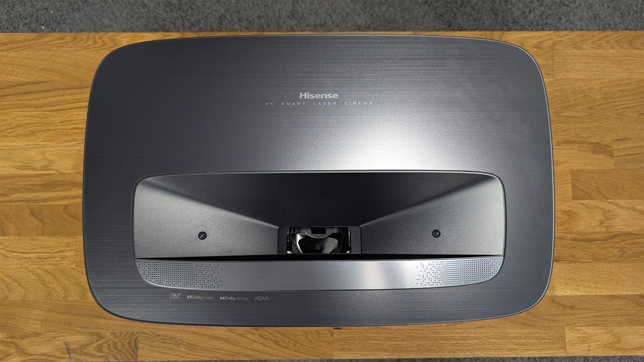 A top-down shot of the Hisense PL2 UST projector on a wooden surface.