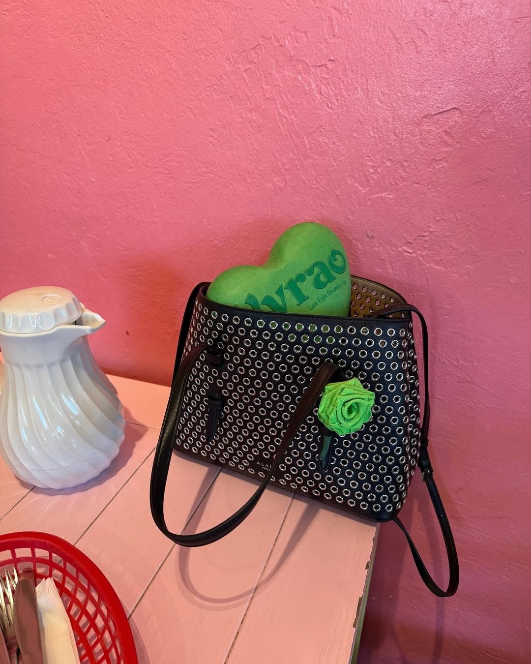Vyrao founder Yasmin Sewell's bag with a Vyrao perfume box sticking out of it.