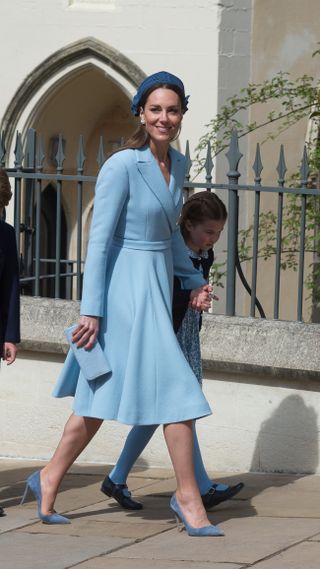 Kate Middleton in a blue dress coat and matching hat and shoes