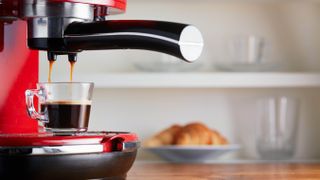 An espresso being poured by an espresso machine