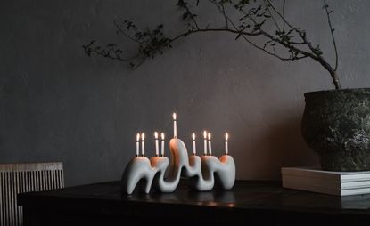 stone menorah with lit candles