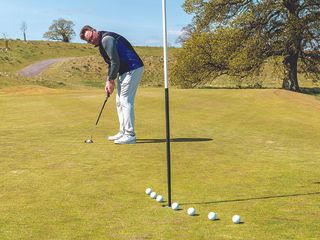 John Jacobs demonstrating reading the line of the putt beyond the hole