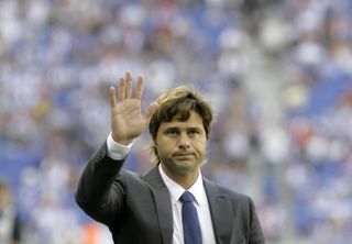 Mauricio Pochettino waves to Espanyol fans ahead of a friendly against Liverpool at the opening of the club's new stadium in 2009.