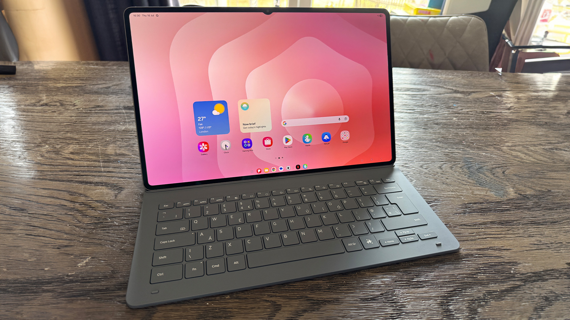 Samsung Galaxy Tab S11 Ultra tablet on wooden table with keyboard attached