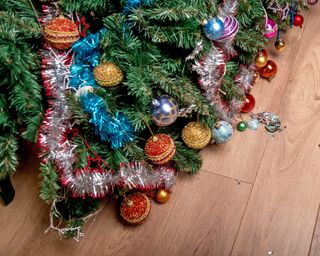 Fallen Christmas tree with broken ornaments