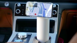 Scosche MagicMount Flask used in car cup holder with iPhone connected to it via MagSafe.