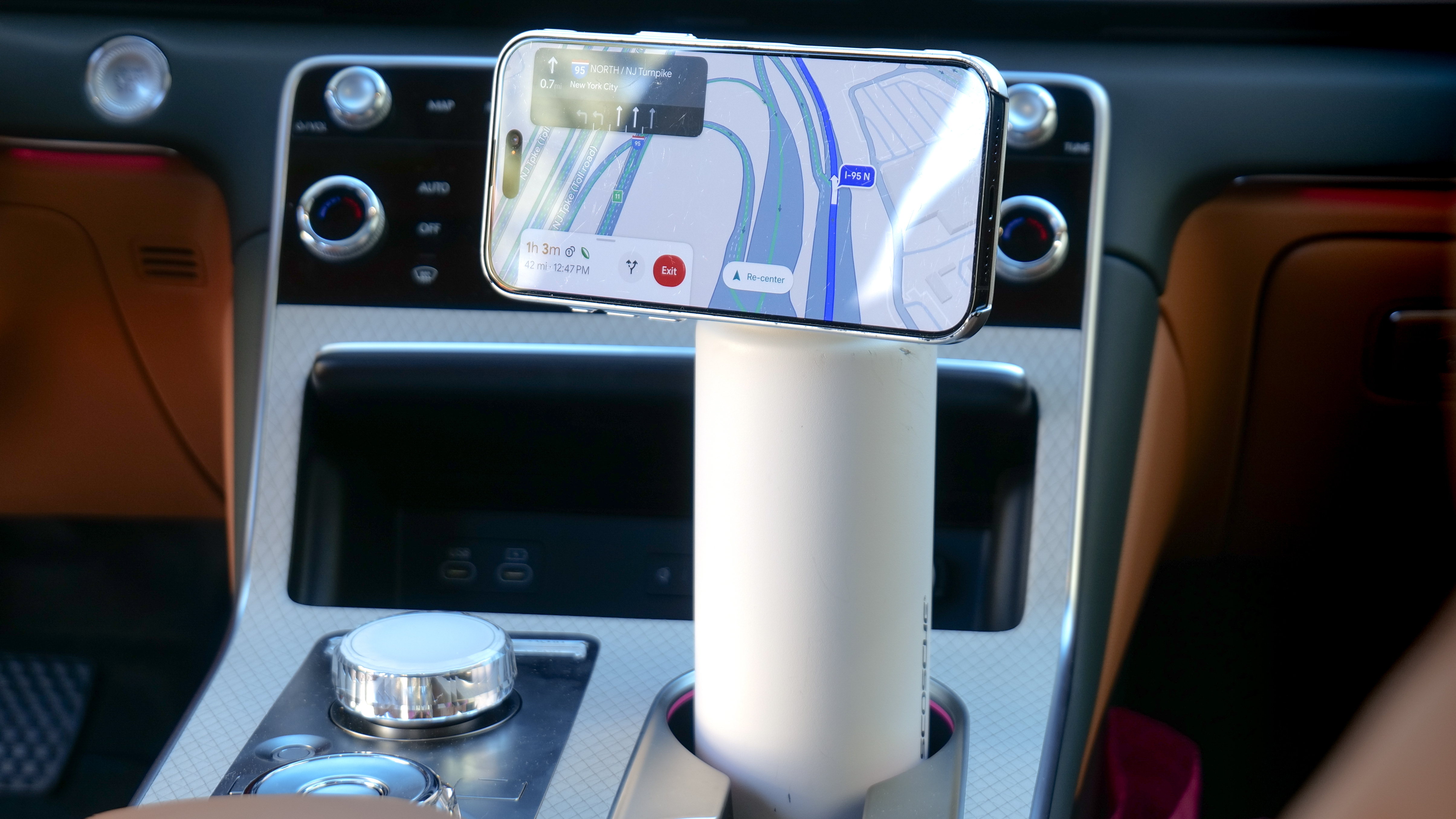 Scosche MagicMount Flask used in car cup holder with iPhone connected to it via MagSafe.