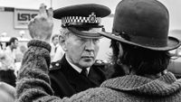 Police confronts protester. 