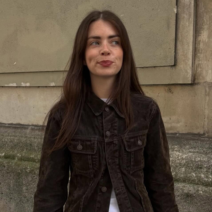 a woman wearing a brown jacket 