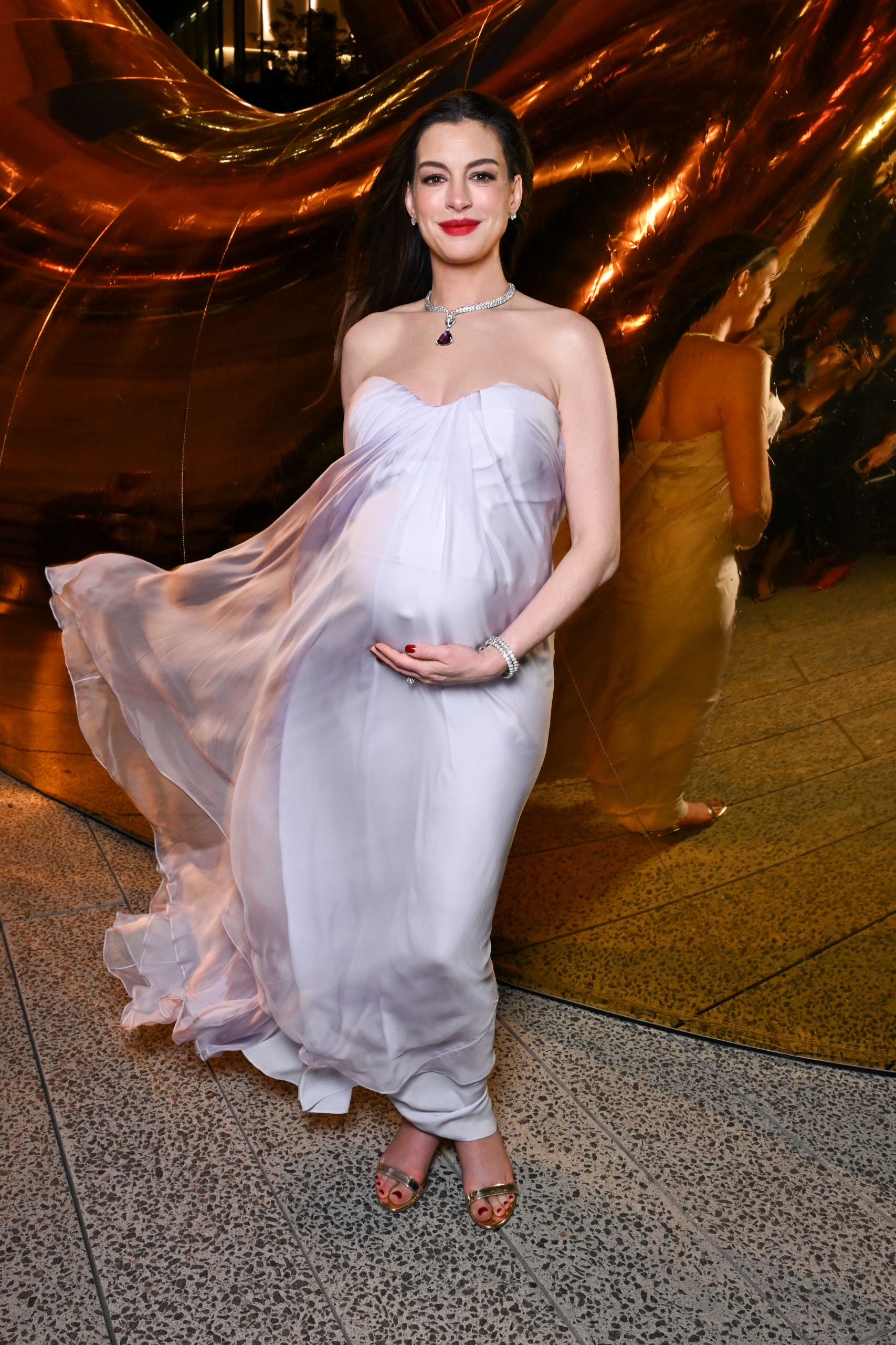 Anne Hathaway brought a little purple purse from Bulgari to a New York Fashion Week event
