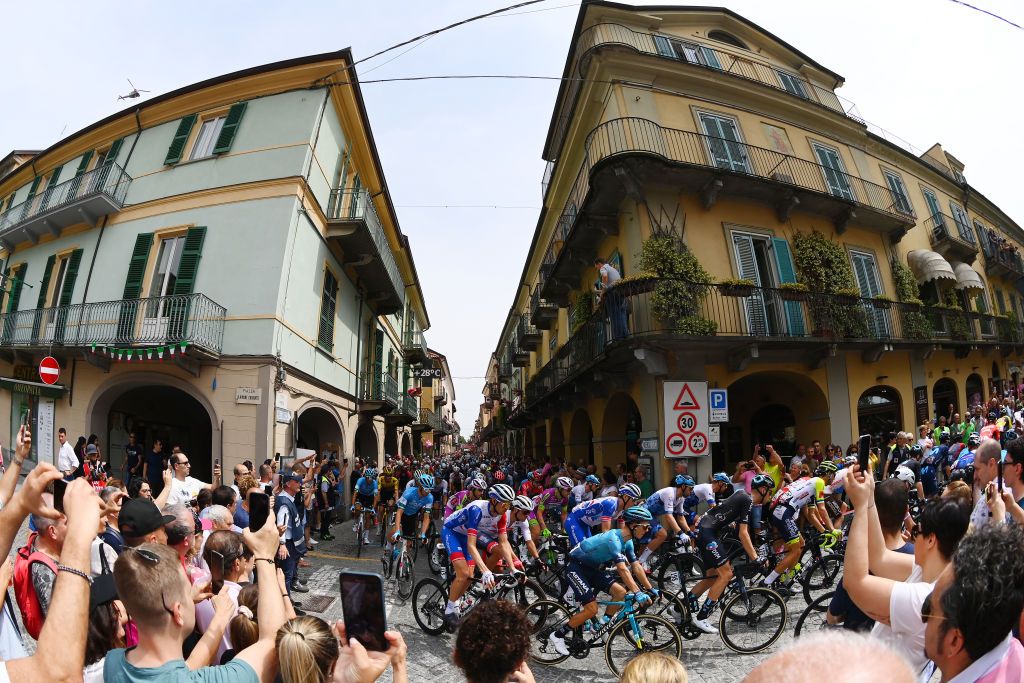 COGNE ITALY MAY 22 Tobias Ludvigsson of Sweden and Team Groupama FDJ Vadim Pronskiy of Kazahkstan and Team Astana Qazaqstan and a general view of the peloton passing through Rivarolo Canavese Village while fans cheer prior to the 105th Giro dItalia 2022 Stage 15 a 177km stage from Rivarolo Canavese to Cogne 1622m Giro WorldTour on May 22 2022 in Cogne Italy Photo by Tim de WaeleGetty Images