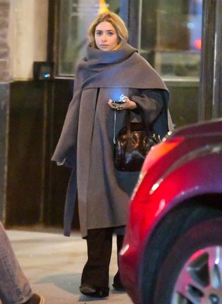 Ashley Olsen wearing an oversize scarf coat with tucked-in hair.