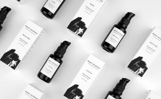 Root Science skincare bottles and boxes lying down