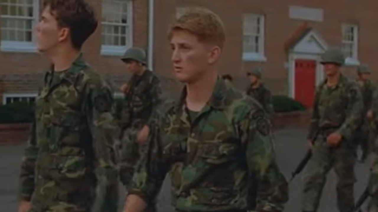 Sean Penn with very short hair and wearing military fatigues in Taps