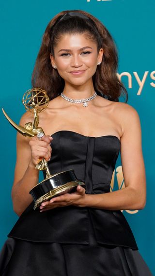 Zendaya posing with her 2022 Emmy award