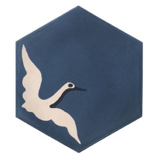 A hexagonal floor tile in midnight blue with an egret bird motif