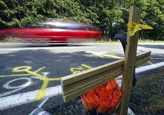 A wooden cross and flowers