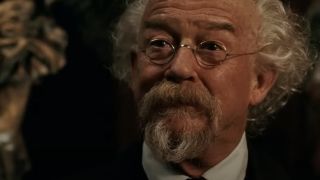 John Hurt as Professor Trevor "Broom" Bruttenholm smirking in Hellboy