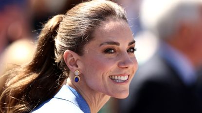 Catherine, Princess of Wales is pictured smiling, with her hair up in a ponytail, as she attends on day four of The Championships Wimbledon 2026 at All England Lawn Tennis and Croquet Club on July 02, 2026 in London, England.
