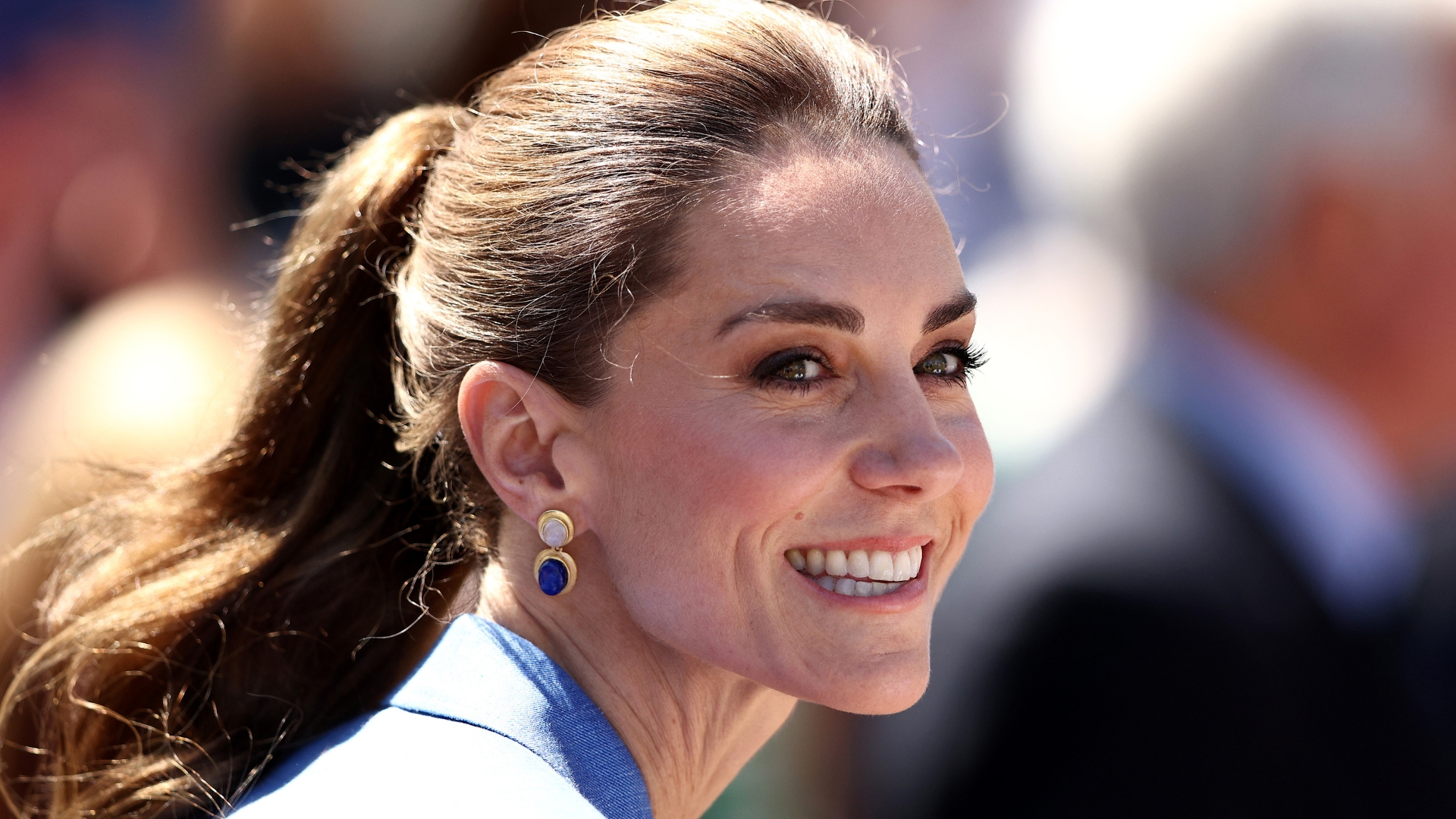 Catherine, Princess of Wales is pictured smiling, with her hair up in a ponytail, as she attends on day four of The Championships Wimbledon 2026 at All England Lawn Tennis and Croquet Club on July 02, 2026 in London, England. 