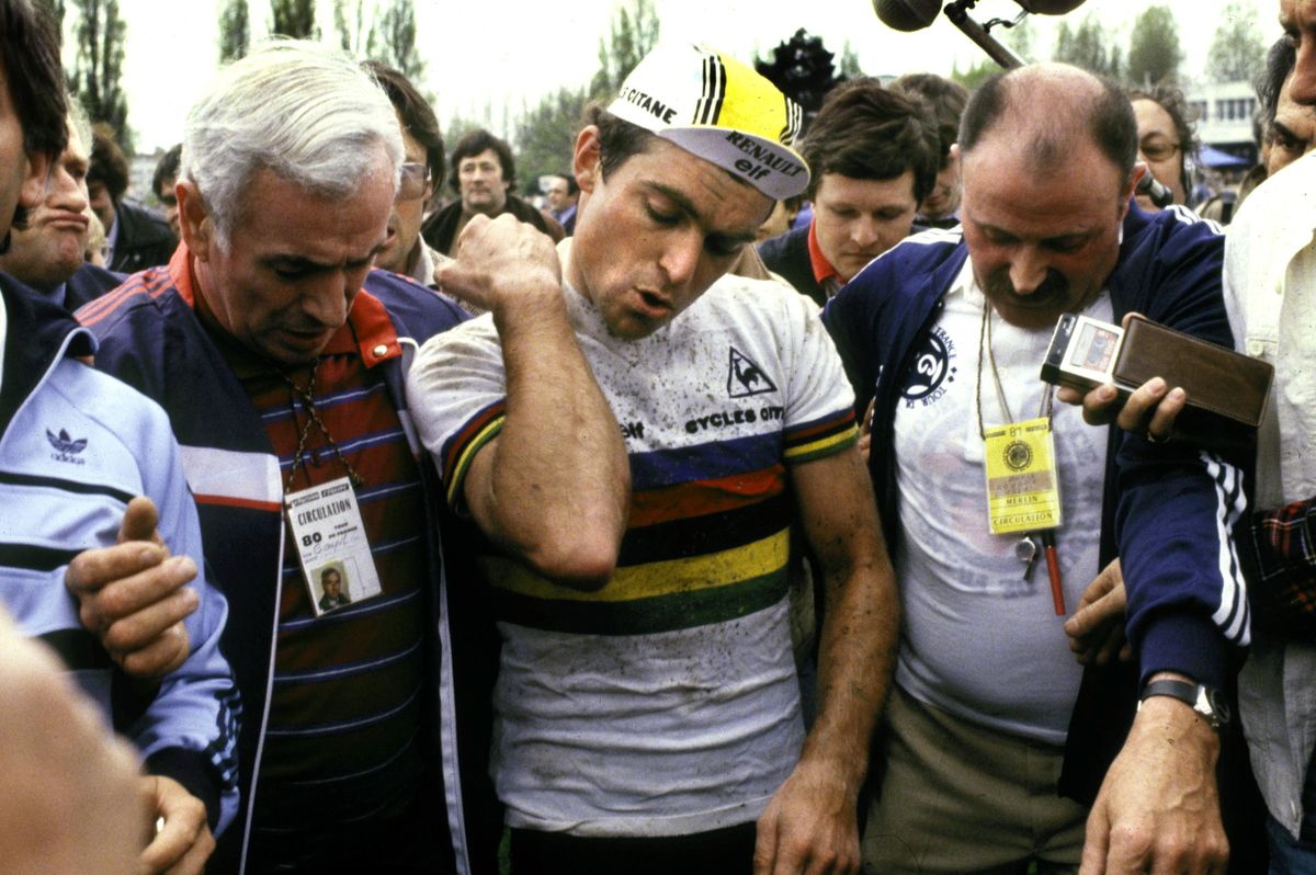 Road race world champion Bernard Hinault (Renault-Elf) &ndash; and in a very similar cap to the one available for sale here on eBay &ndash; checks himself over after multiple crashes on his way to winning the 1981 Paris-Roubaix