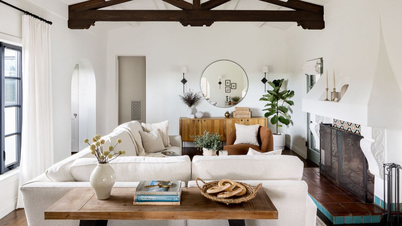 White living room with dark wooden beams