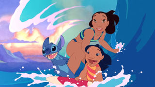 Still from the animated movie Lilo & Stitch (2002). A young girl, her older sister, and a blue, koala-like alien are all on a surfboard having a fantastic time riding a big ocean wave.