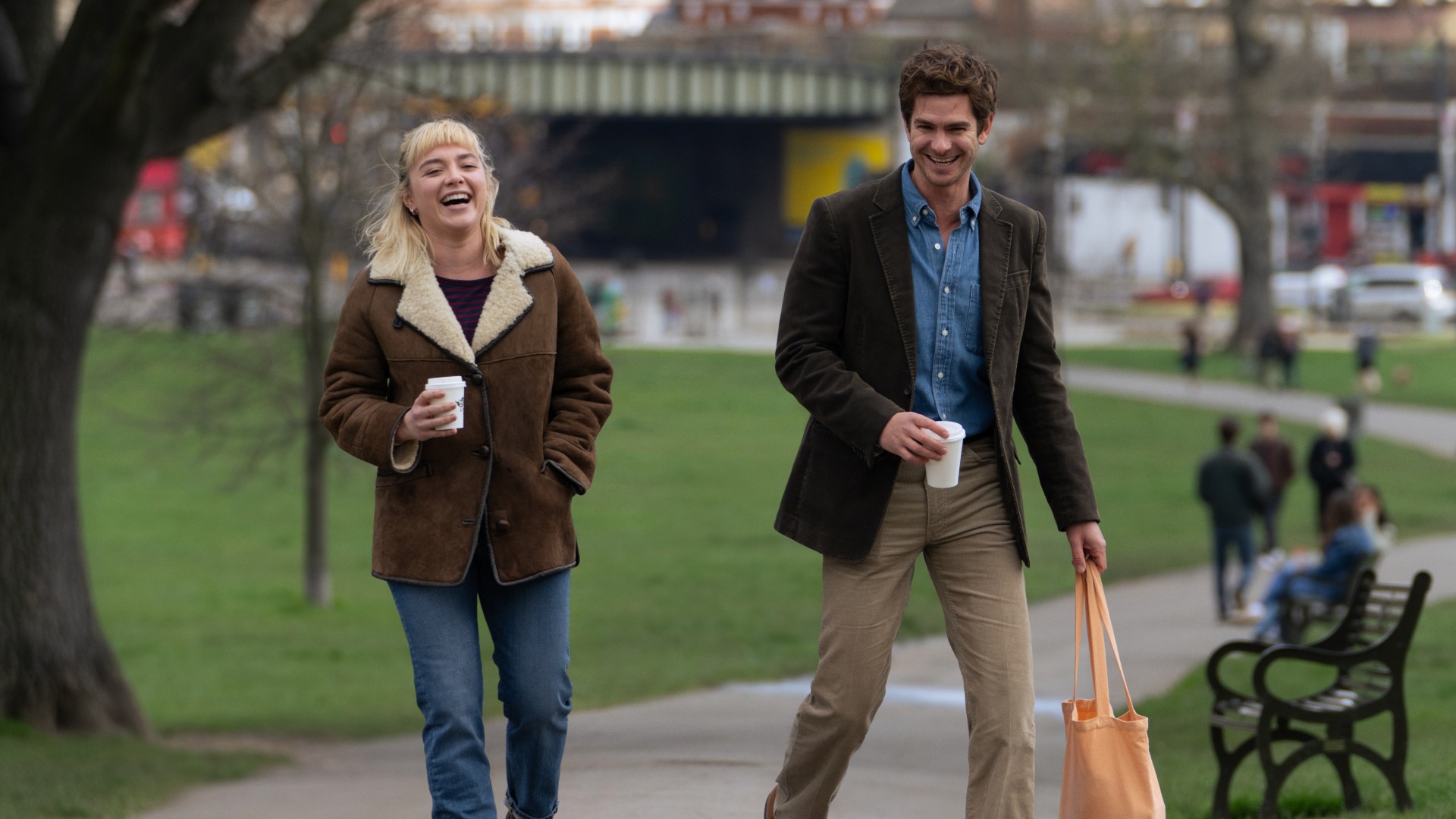 Florence Pugh on the left walking with Andrew Garfield who is stood on the right in the film We Live in Time 