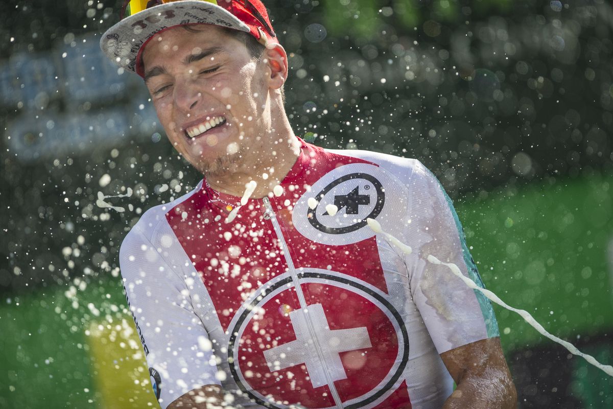 Simon Pellaud sprays the champagne on the podium