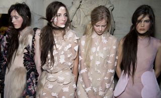 four female models wearing beige coloured dresses by simone rocha