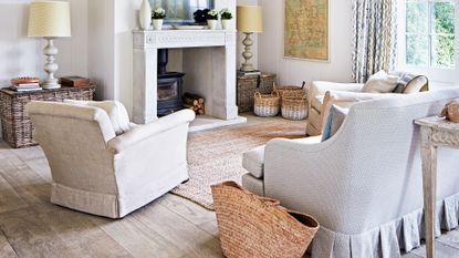  Living room with television, woodburner in a fireplace, sofas and chairs. A new build property in Georgian style, newly refurbished family home of Fi Crole and her family in Hampshire.