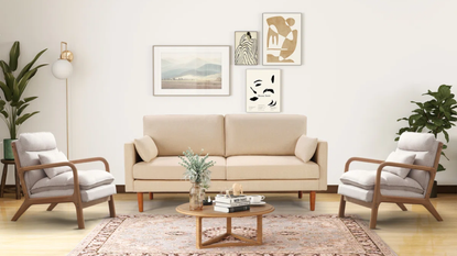 a living room with a small couch, two accent chairs, a small coffee table, and an arrangement of photos on the wall