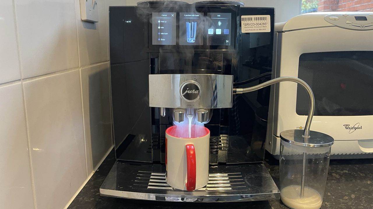 JURA GIGA 10 pouring hot milk into coffee