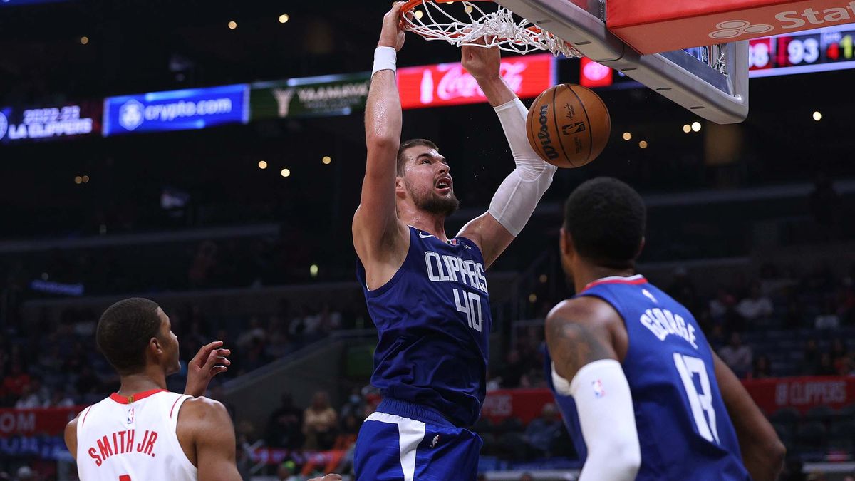 Ivica Zubac #40 of the LA Clippers dunks from a Paul George #13 pass in front of Jabari Smith Jr. #1 of the Houston Rockets during the second half in a 95-93 Clipper win at Crypto.com Arena on October 31, 2022 in Los Angeles, California.