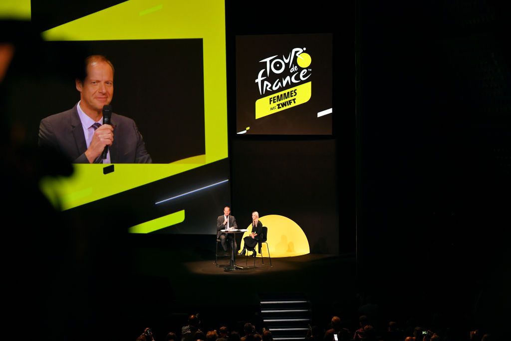 PARIS FRANCE OCTOBER 14 LR Christian Prudhomme of France Director of Le Tour de France and Marion Rousse of France Director of the womens Tour de France speak during the 109th Tour de France 2022 And 1st Tour de France Femmes 2022 Route Presentation TDF2022 LeTour on October 14 2021 in Paris France Photo by Luc ClaessenGetty Images