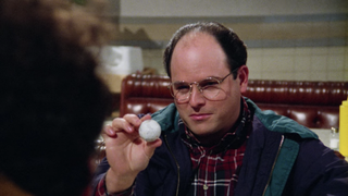 George Costanza holding a golf ball in The Marine Biologist, one of the best seinfeld episodes