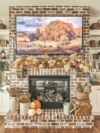 Dried grasses, pumpkins and leaf garland fireplace Thanksgiving decor idea