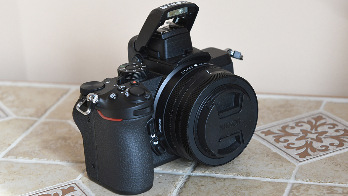 The Nikon Z50 on a tiled floor with a floral pattern