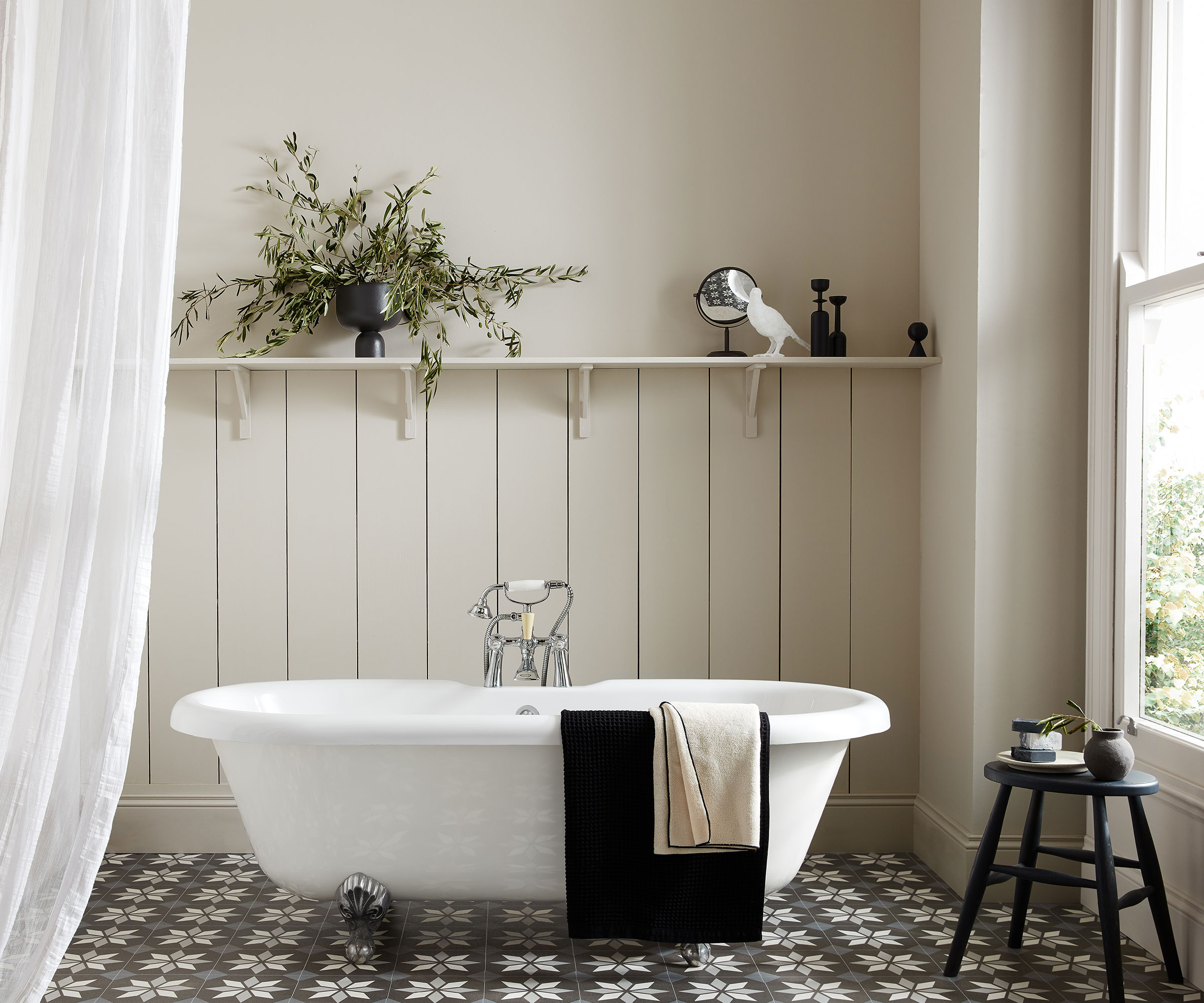 neutral bathroom with off-white bathroom panelling and Moroccan floor tiles