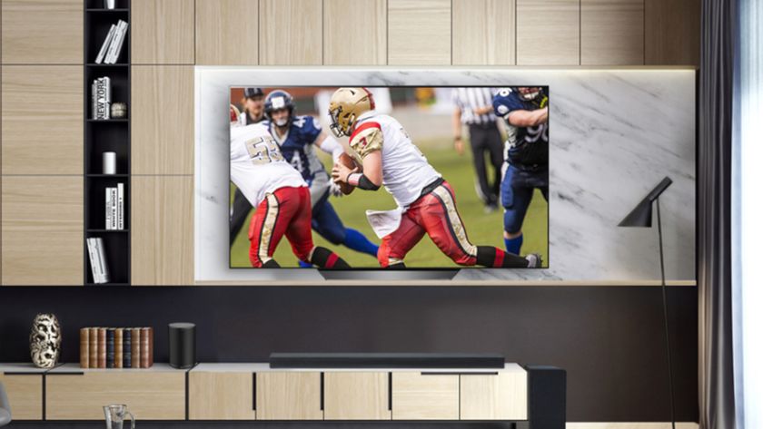 The LG B8 OLED TV in a modern living room displaying an NFL football game