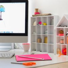 desk with shelves and computers