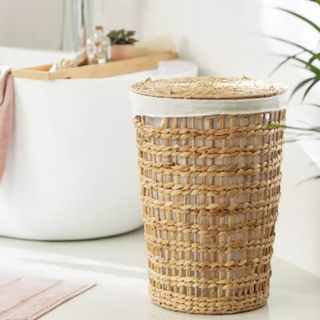 Habitat 102 Litre Water Hyacinth Laundry Basket in a white bathroom