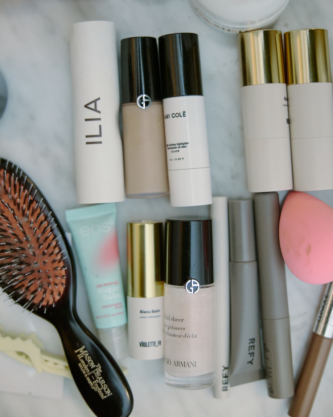 Makeup, skincare, and hair products on a counter.