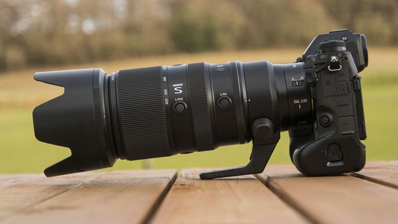 A Nikon Z telephoto lens on a wooden table