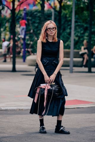 Tyler Joe photographs a NYFW SS24 guest in a street style outfit