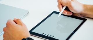 Man using tablet with a stylus to make a logo or graphic design
